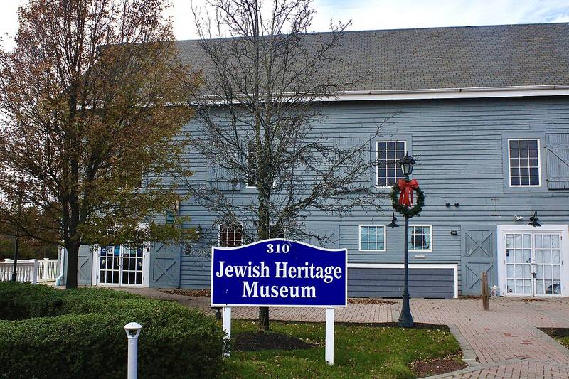 The Jewish Heritage Museum sign in front of a restored gray barn