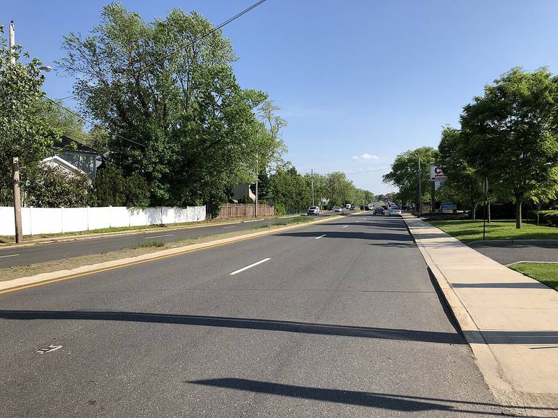 Tree-lined Norwood Avenue at Jerome Avenue, on the line between Oakhurst and Deal