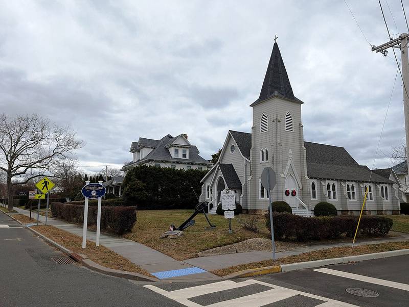 St. Andrew's by the Sea Episcopal Church with the New Era anchor on its lawn and an Allenhurst welcome sign