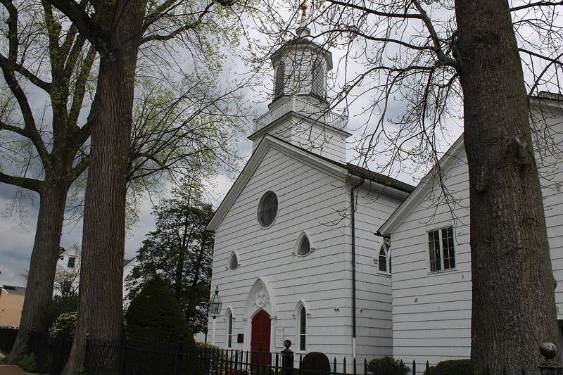 St. Peter's Episcopal Church, a white wooden church with a cupola and red door