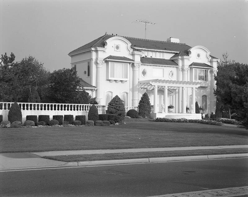 Black-and-white photo of a large stucco house with columns on the Deal oceanfront