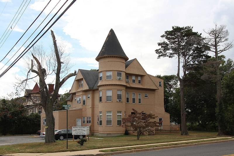 A shingled Victorian house with a round turret on Cedar Avenue in West Long Branch, New Jersey